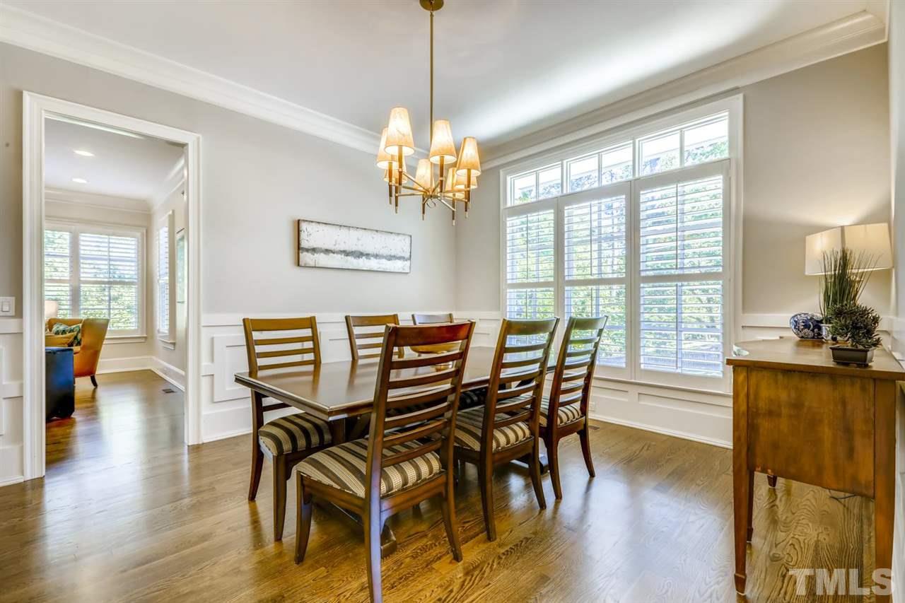 2827 Lewis Farm Road Raleigh, NC 27607 - Photo 4 of 30 Intricate Woodwork Below the Chair Rail, a Wall of Windows, A Butler's Pantry with Wine Fridge, Room for a Huge Table, and that Chandelier Make this Dining Room Extra Special.