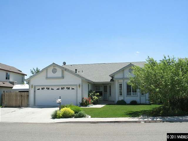 5860 Mitra Way Reno, NV 89523 - Photo 1 of 5 a view of a house with a yard and a garage