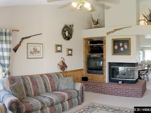 5860 Mitra Way Reno, NV 89523 - Photo 3 of 5 a living room with furniture flat screen tv and a fireplace