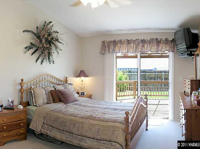 5860 Mitra Way Reno, NV 89523 - Photo 4 of 5 a bedroom with a large bed and a tv