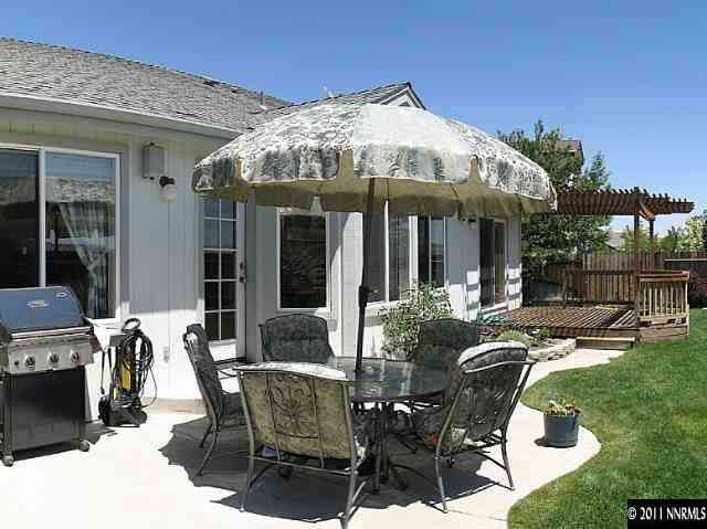 5860 Mitra Way Reno, NV 89523 - Photo 5 of 5 a patio with a table and chairs and potted plants