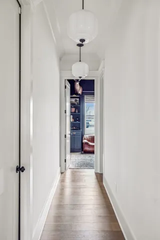 a view of a hallway with a chandelier