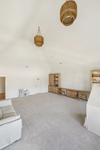 a view of a livingroom with furniture and chandelier fan