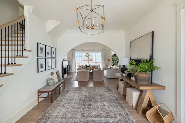a living room with furniture and a potted plant