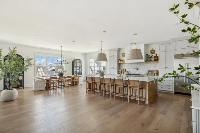 a living room with lots of furniture and kitchen view