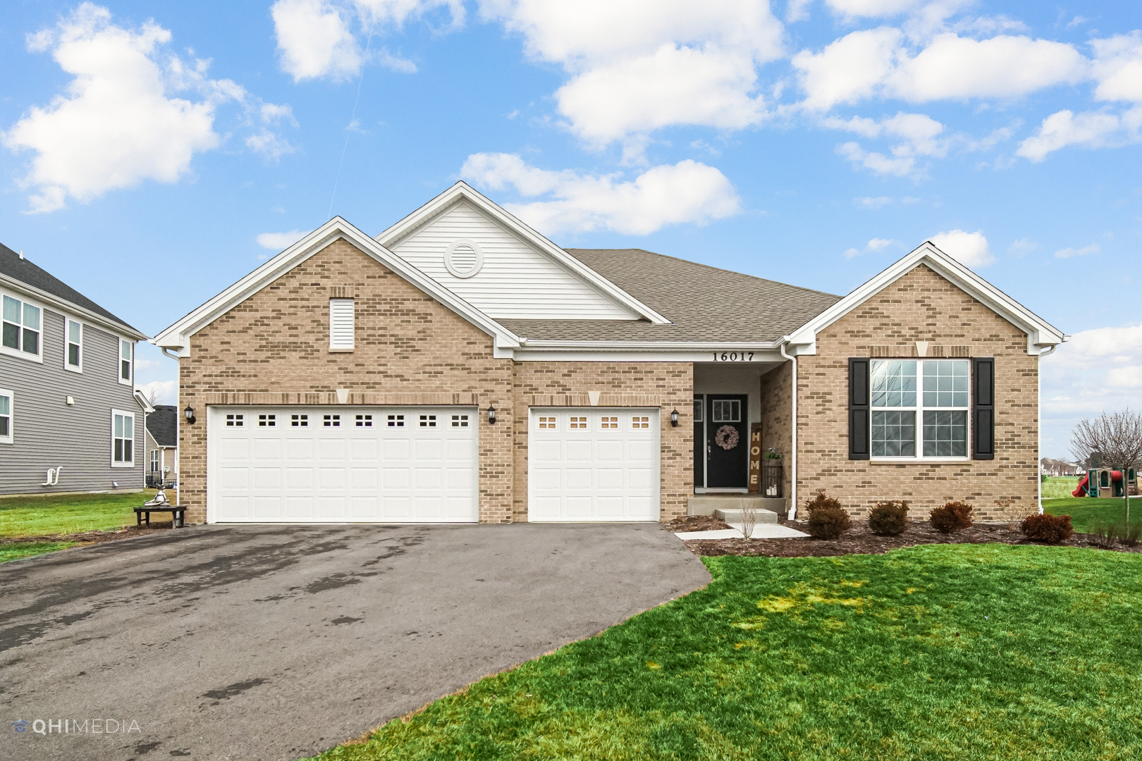 a front view of a house with a garden