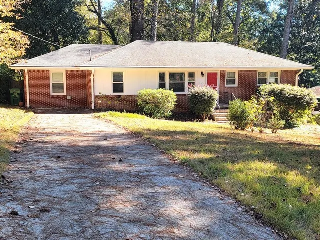 a view of a yard in front of a house with large trees