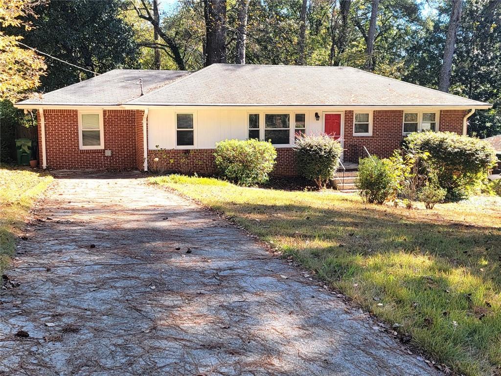 a view of a yard in front of a house with large trees