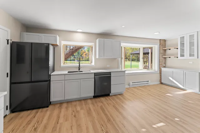 a kitchen with a refrigerator and a sink