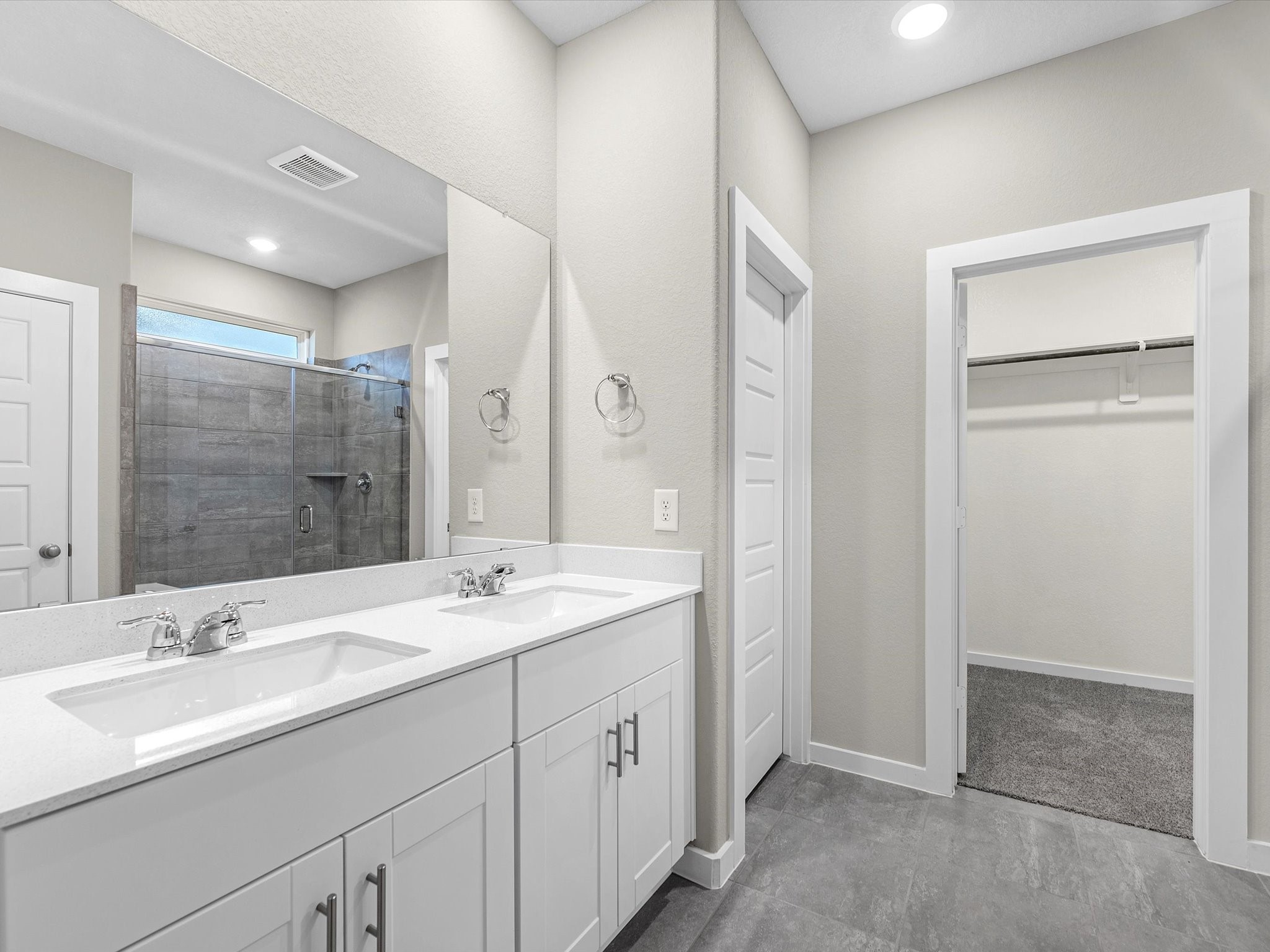 1749 Succotash Oak Court Conroe, TX 77304 - Photo 12 of 21 a spacious bathroom with a double vanity sink mirror and