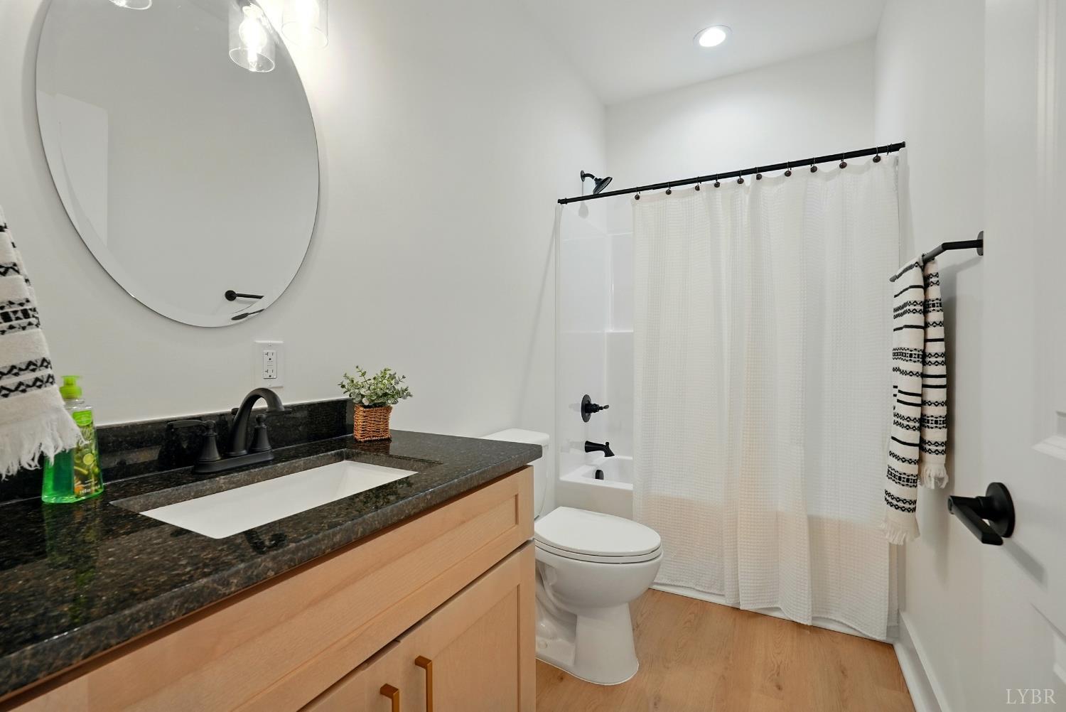1 Golf Club Road Danville, VA 24540 - Photo 26 of 33 a bathroom with a granite countertop sink a toilet and a mirror