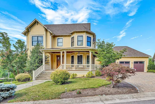 a view of a house with large windows and stairs