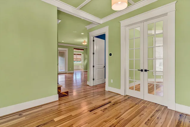 a view of a room with wooden floor and window