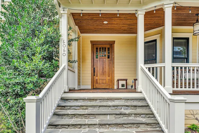a view of backyard with wooden floor and iron fence