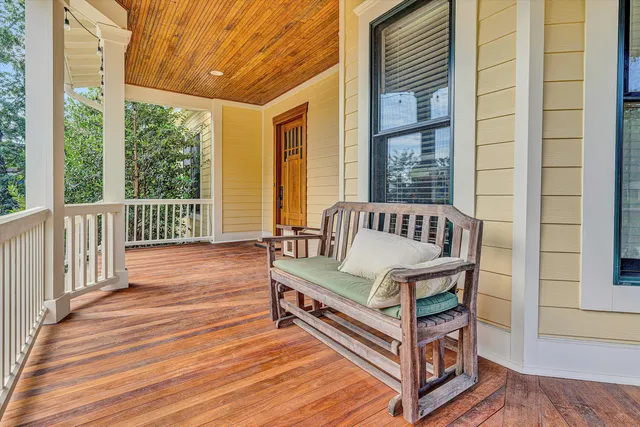 a view of a room with wooden floor and windows