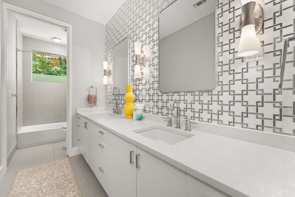 4908 Beverly Skyline Austin, TX 78731 - Photo 26 of 40 Bathroom with double vanity, light tile patterned flooring, bathing tub / shower combination, and decorative backsplash