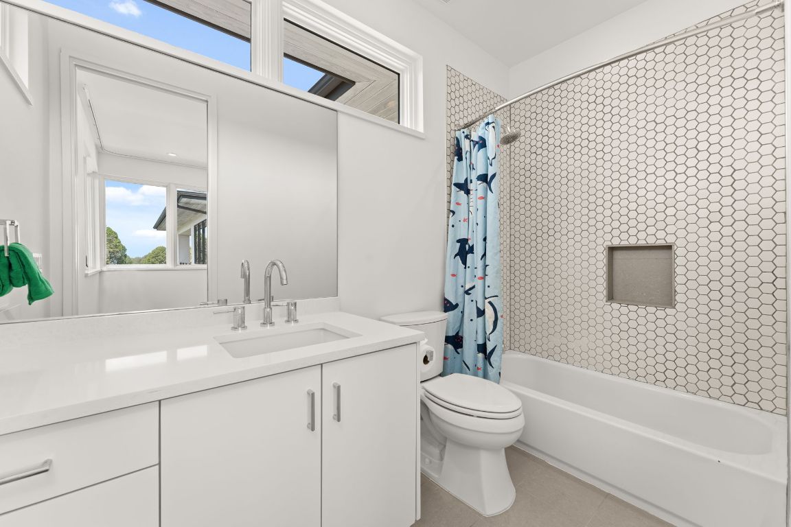 4908 Beverly Skyline Austin, TX 78731 - Photo 29 of 40 Full bathroom featuring shower / tub combo, vanity, and light tile patterned flooring