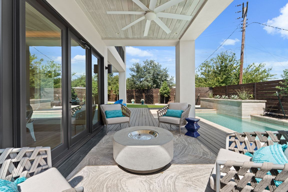 4908 Beverly Skyline Austin, TX 78731 - Photo 32 of 40 Fenced backyard featuring ceiling fan, a patio, and a fire pit