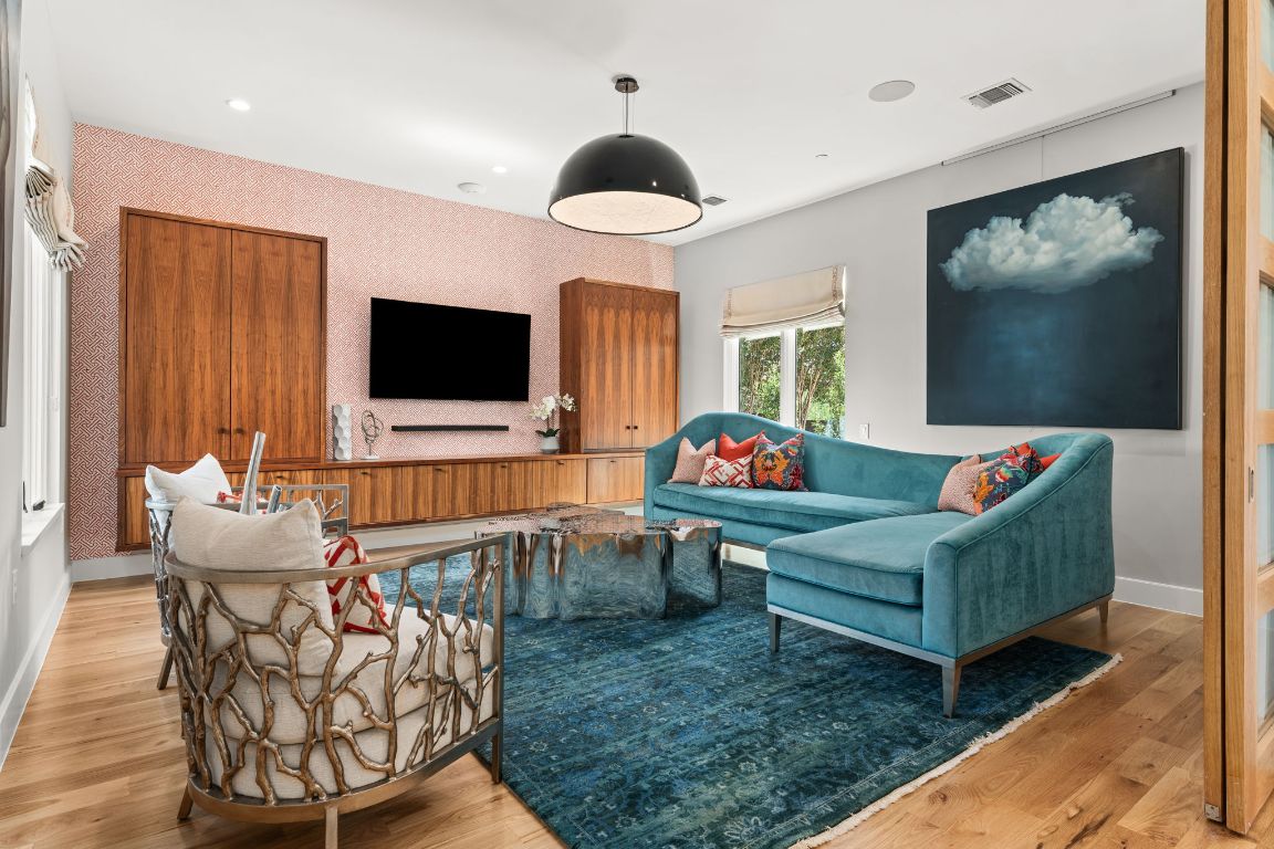 4908 Beverly Skyline Austin, TX 78731 - Photo 6 of 40 Living room featuring light wood-style flooring, wallpapered walls, an accent wall, and recessed lighting