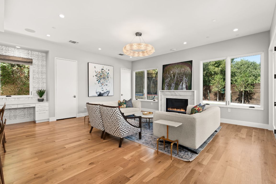 4908 Beverly Skyline Austin, TX 78731 - Photo 7 of 40 Living room with recessed lighting, light wood finished floors, and a fireplace