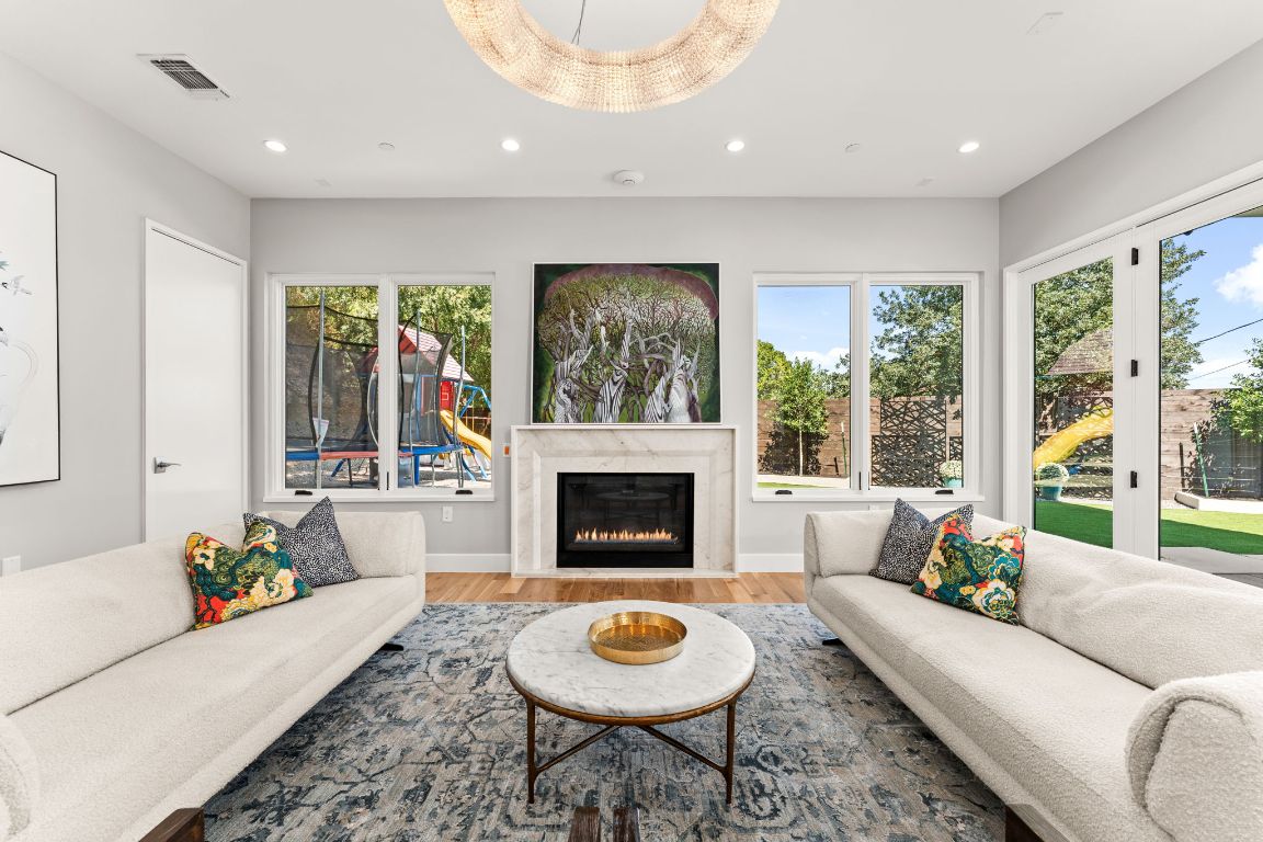 4908 Beverly Skyline Austin, TX 78731 - Photo 8 of 40 Living room featuring recessed lighting, wood finished floors, and a premium fireplace