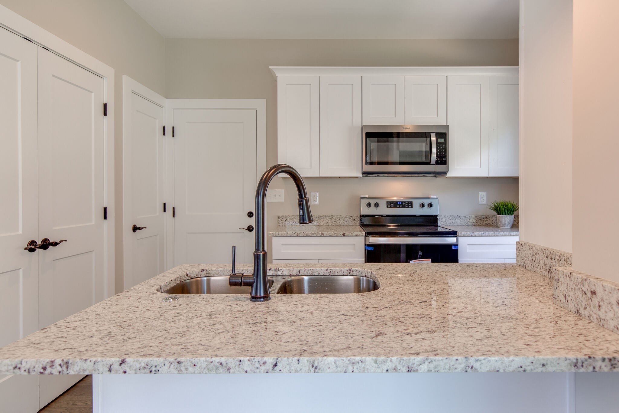 1026 Sycamore Ridge East, Unit 44 Burns, TN 37029 - Photo 14 of 28 a kitchen with stainless steel appliances granite countertop a stove a sink and a white refrigerator
