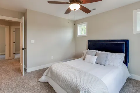 a bedroom with a large bed and a chandelier
