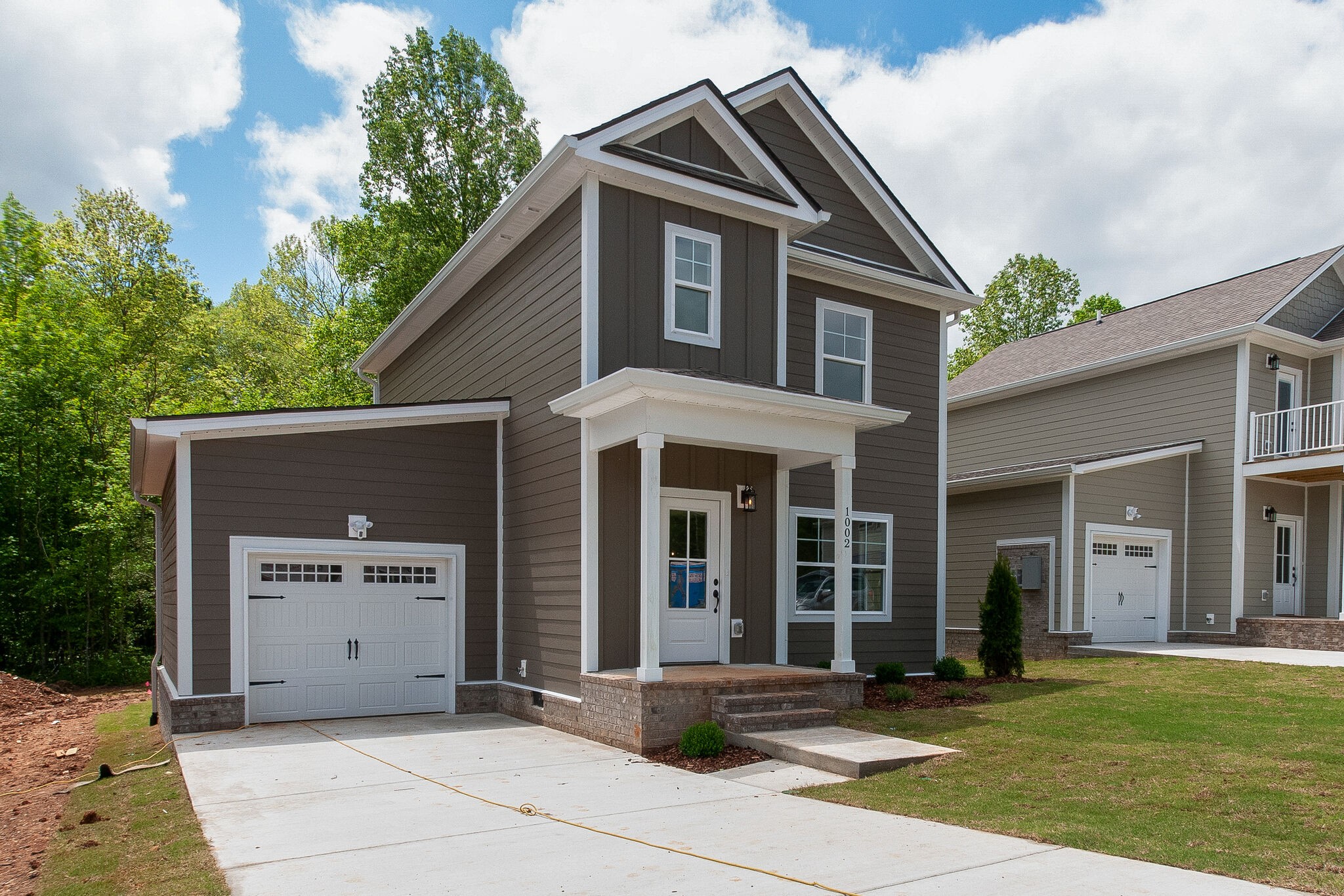 1026 Sycamore Ridge East, Unit 44 Burns, TN 37029 - Photo 2 of 28 a view of a house with a yard