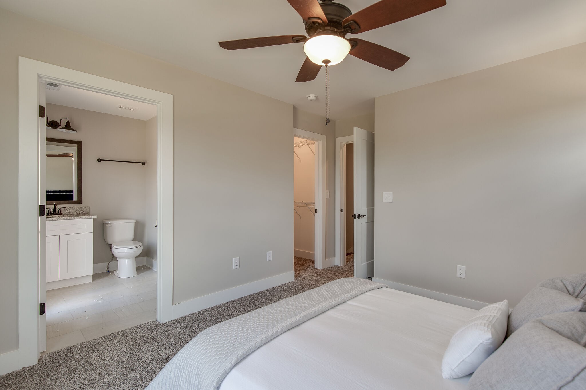 1026 Sycamore Ridge East, Unit 44 Burns, TN 37029 - Photo 22 of 28 a bedroom with a bed and a chandelier