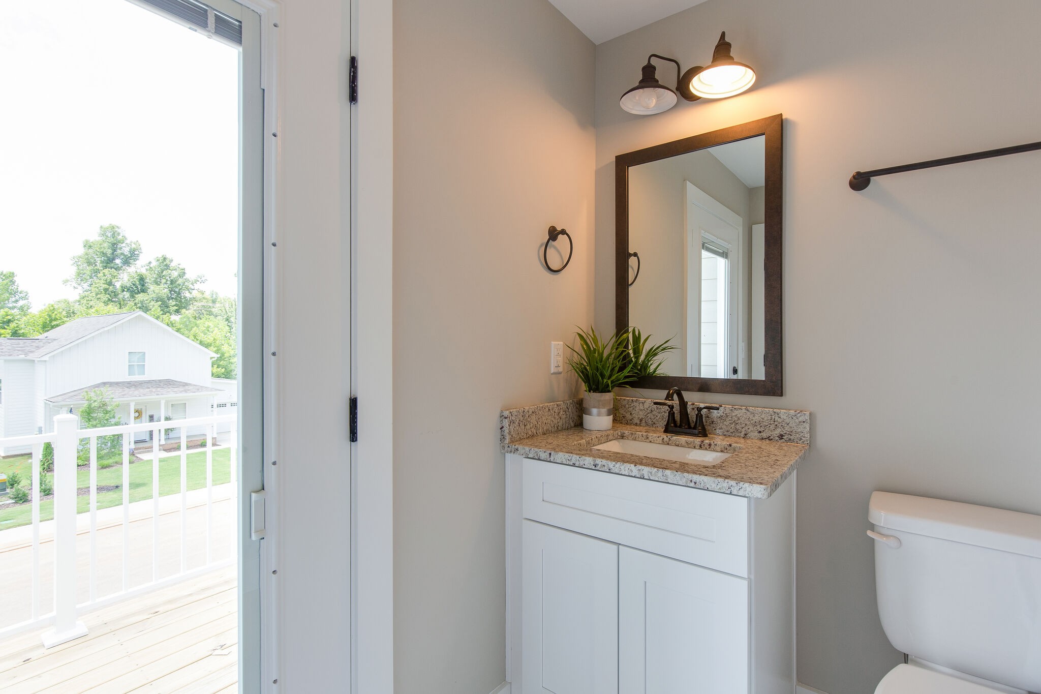 1026 Sycamore Ridge East, Unit 44 Burns, TN 37029 - Photo 23 of 28 a bathroom with a toilet sink and mirror