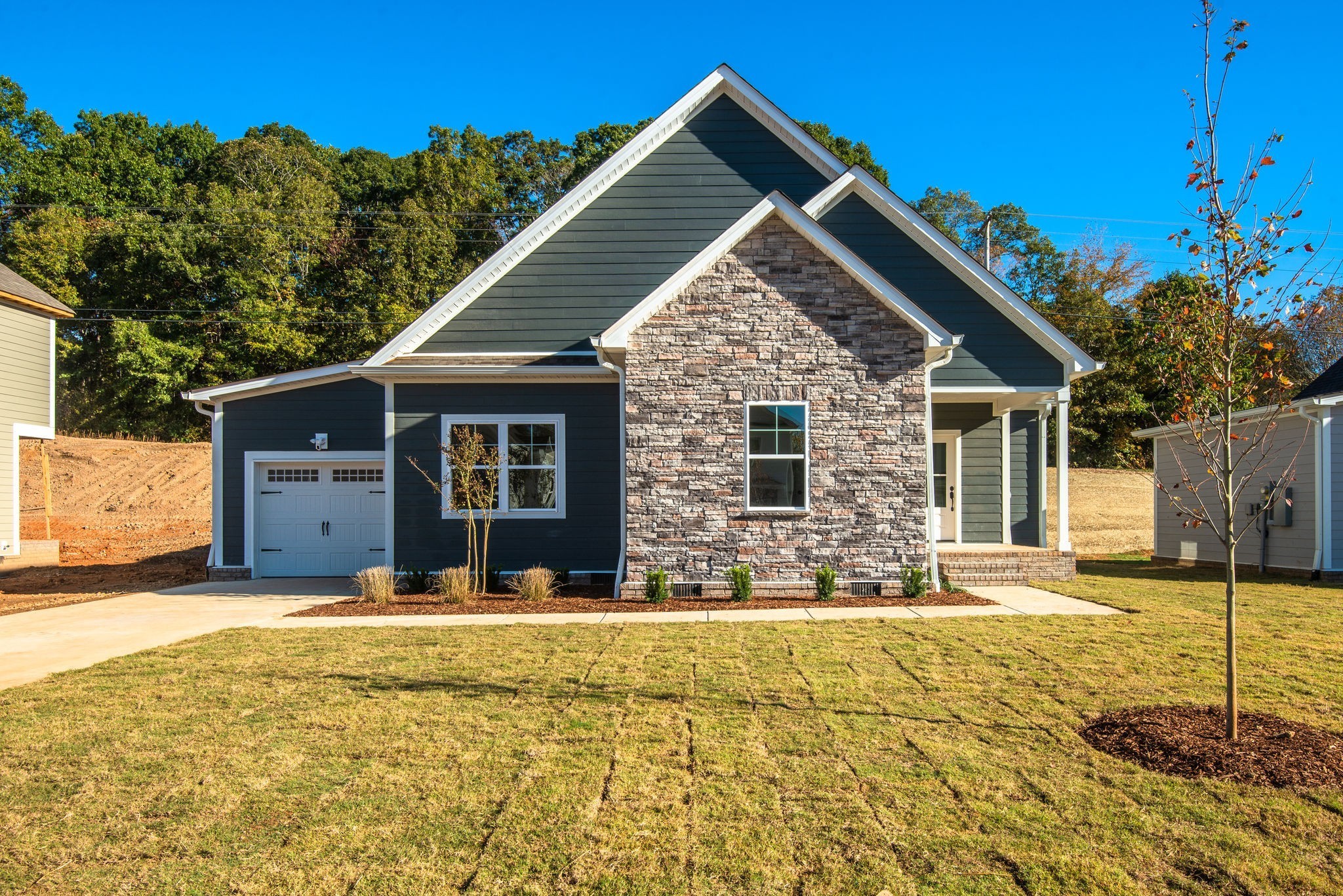 1026 Sycamore Ridge East, Unit 44 Burns, TN 37029 - Photo 3 of 28 a front view of a house with a yard