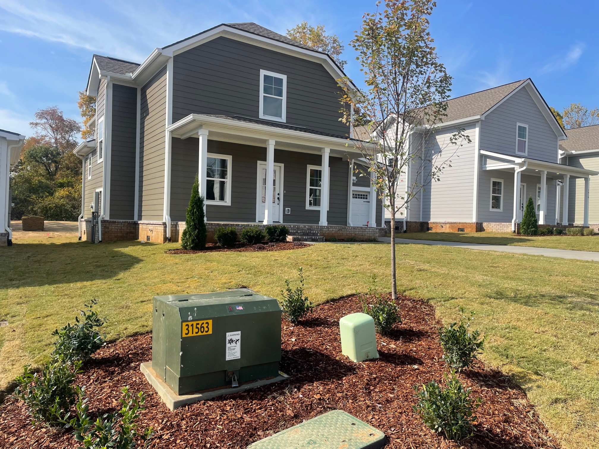 1026 Sycamore Ridge East, Unit 44 Burns, TN 37029 - Photo 7 of 28 a view of a white house with swimming pool lawn chairs and couches