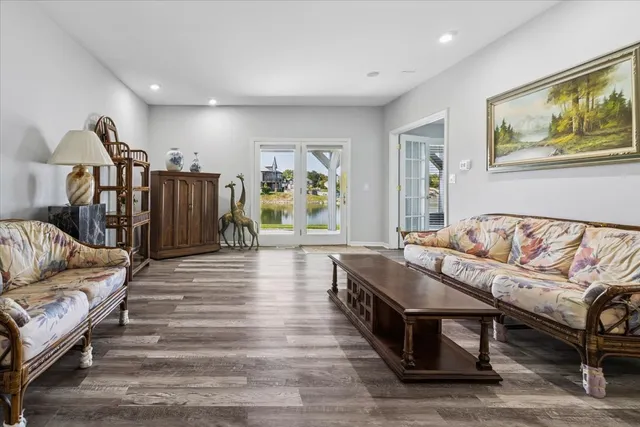 a living room with furniture and a painting on the wall