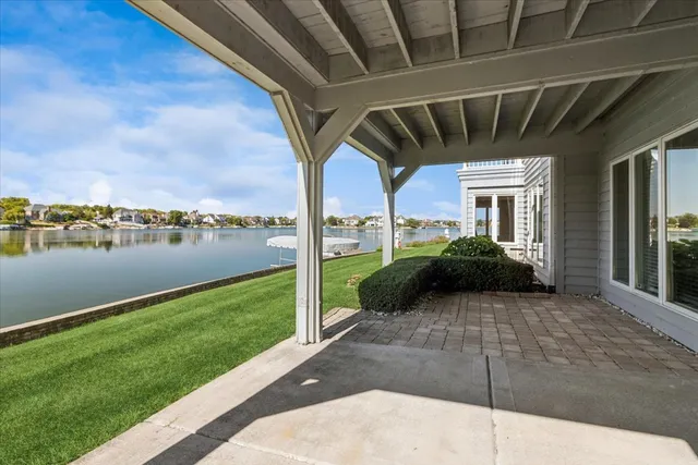 a view of a couches under an umbrella in front of house
