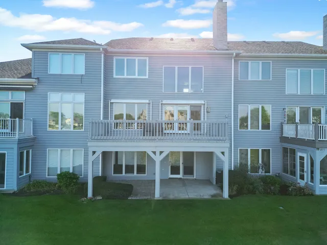 a view of front of brick building with a yard