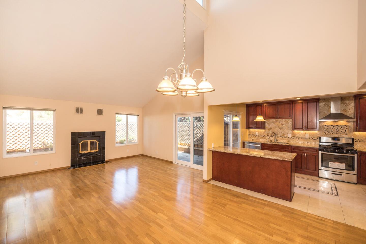 1170 Rickover Lane Foster City, CA 94404 - Photo 11 of 45 a view of a kitchen with granite countertop stainless steel appliances and a fireplace