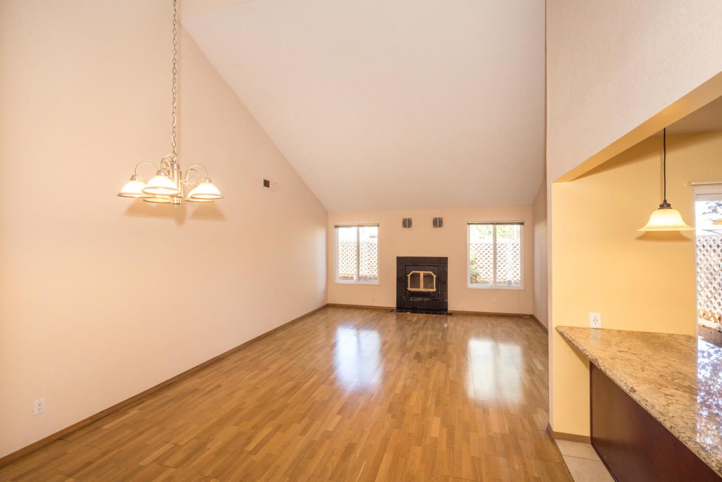 1170 Rickover Lane Foster City, CA 94404 - Photo 12 of 45 a view of a room with wooden floor and a fireplace