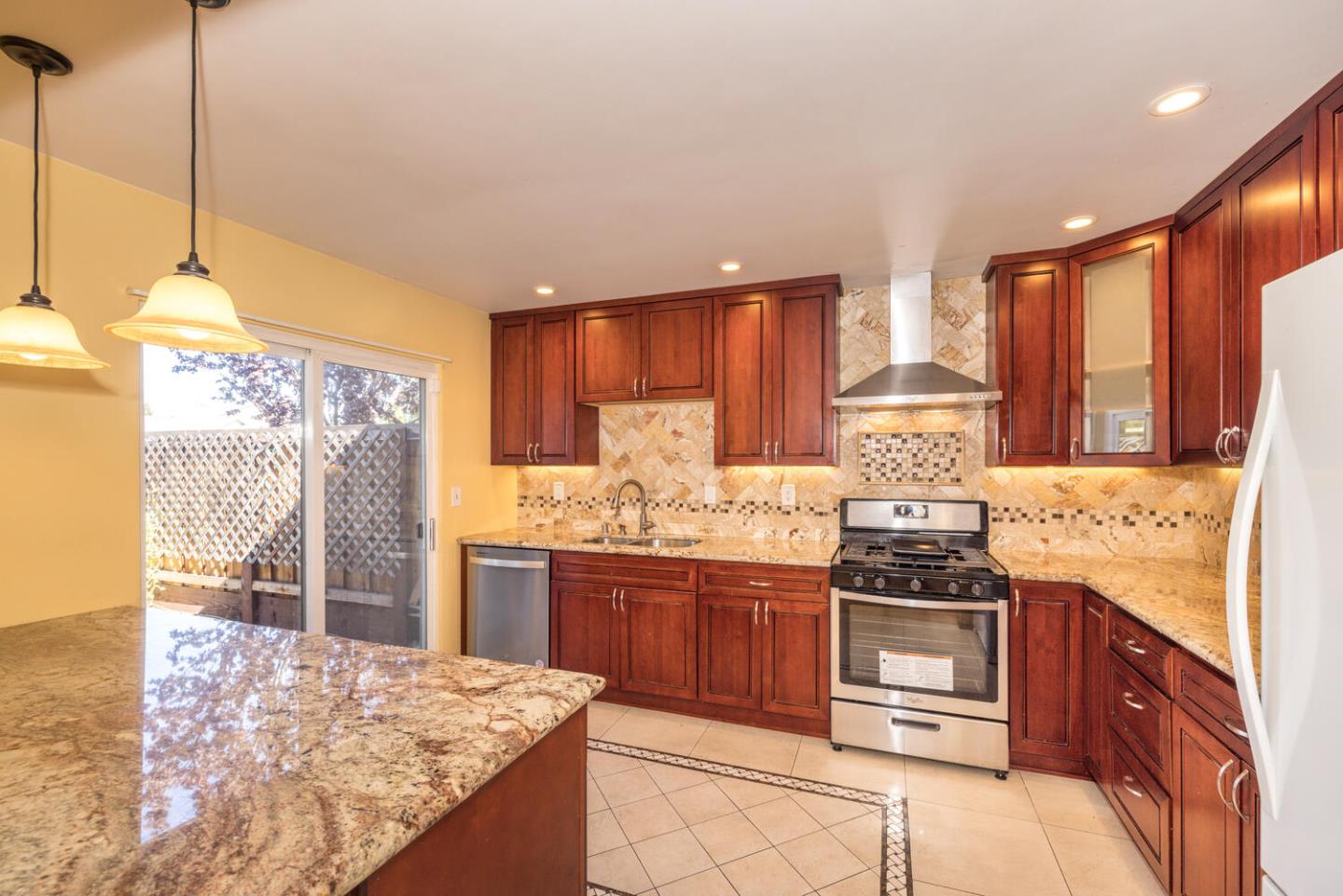 1170 Rickover Lane Foster City, CA 94404 - Photo 14 of 45 a kitchen with stainless steel appliances granite countertop a stove a sink and a refrigerator