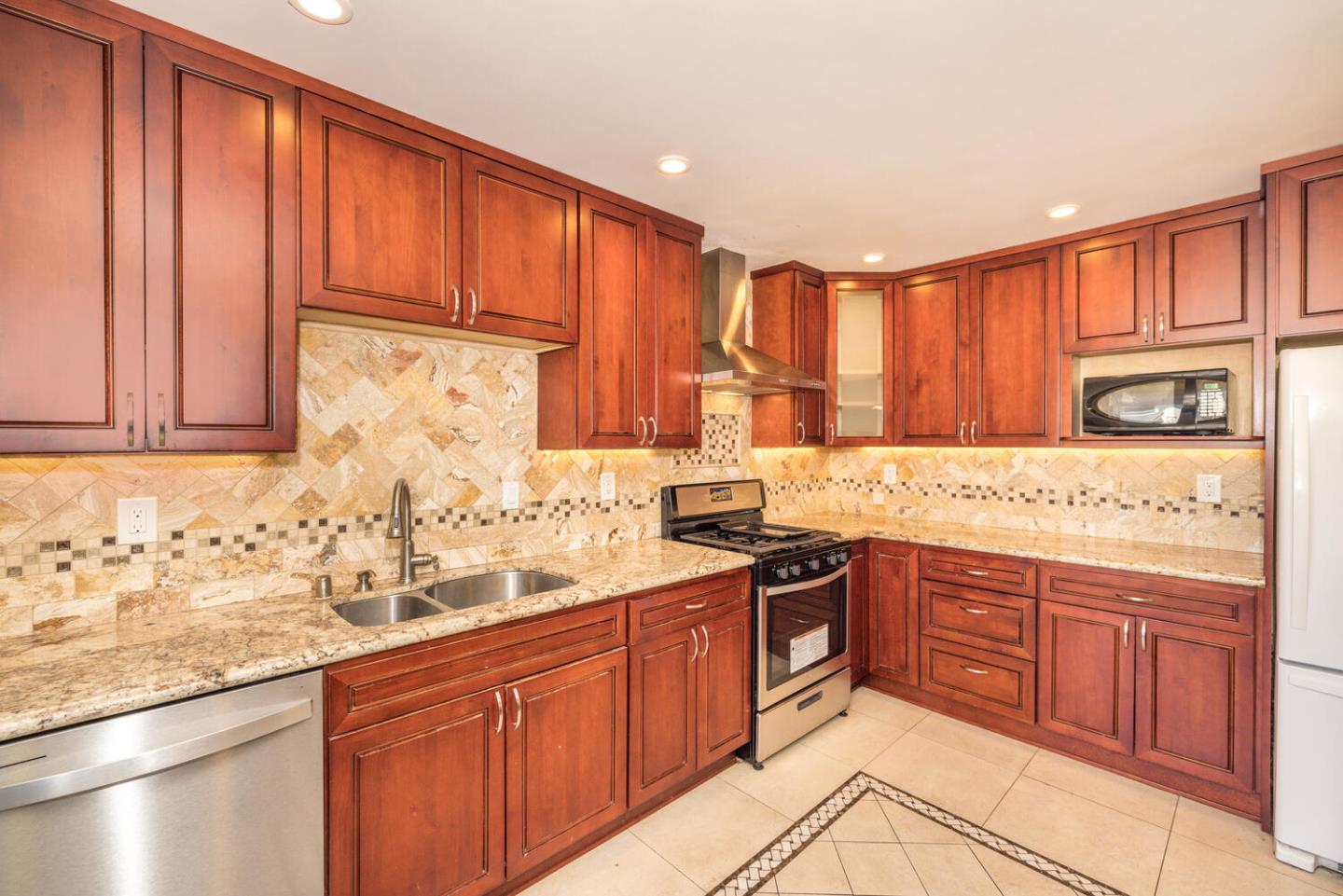 1170 Rickover Lane Foster City, CA 94404 - Photo 15 of 45 a kitchen with stainless steel appliances granite countertop a sink stove and cabinets