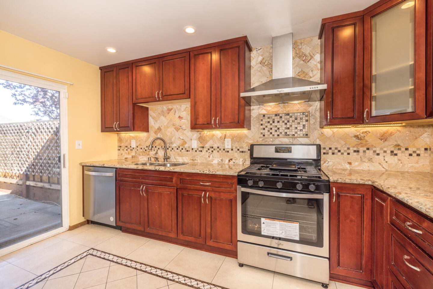1170 Rickover Lane Foster City, CA 94404 - Photo 17 of 45 a kitchen with granite countertop a stove sink and cabinets