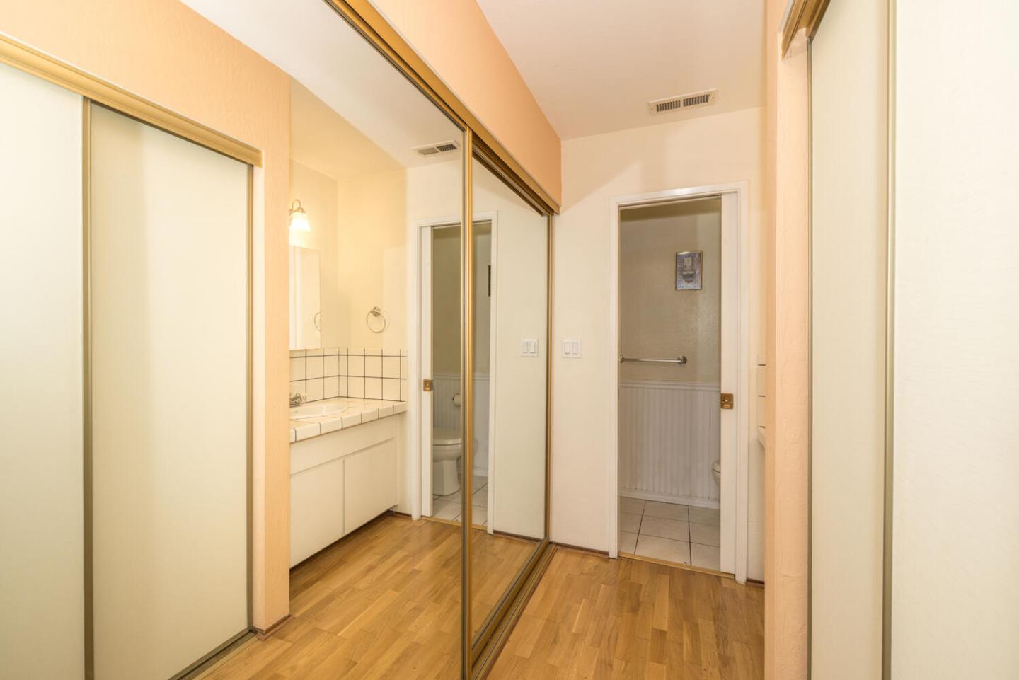 1170 Rickover Lane Foster City, CA 94404 - Photo 22 of 45 a view of a hallway with wooden floor
