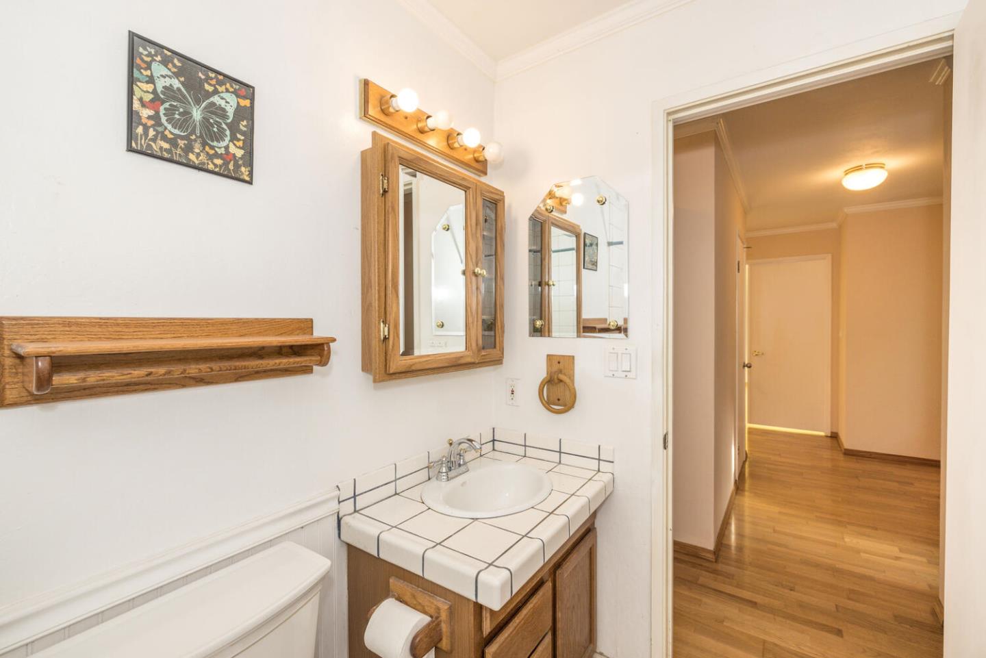 1170 Rickover Lane Foster City, CA 94404 - Photo 30 of 45 a bathroom with a sink a mirror and a shower