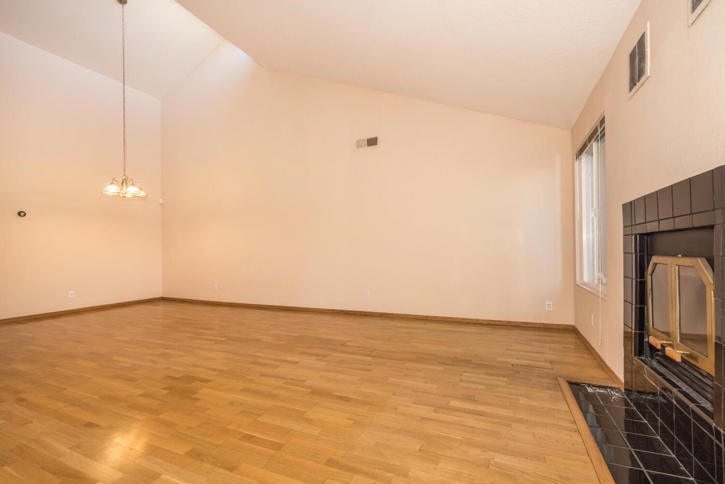 1170 Rickover Lane Foster City, CA 94404 - Photo 8 of 45 a view of an empty room with wooden floor and a window