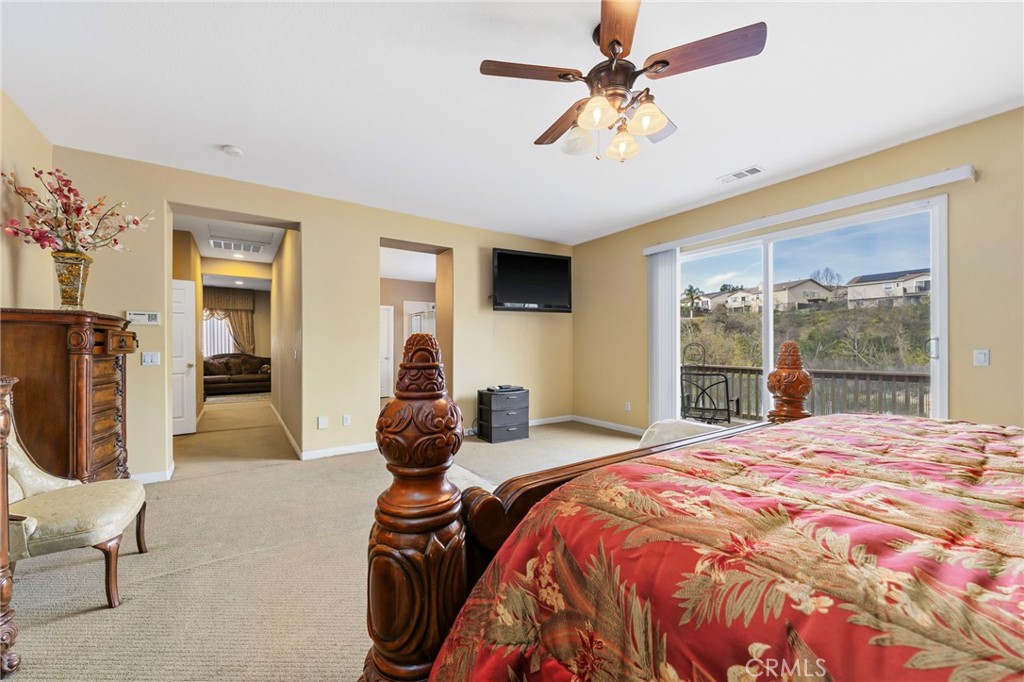 36005 Redgrave Way Murrieta, CA 92562 - Photo 23 of 42 a bedroom with a bed a window and a chandelier