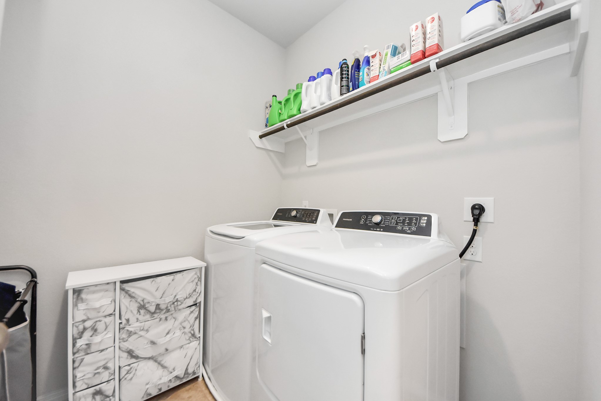3310 Rainflower Springs Lane Rosenberg, TX 77471 - Photo 15 of 31 Convenient laundry room with ample shelving for storage, a marble-finished cabinet, and modern washer and dryer appliances.