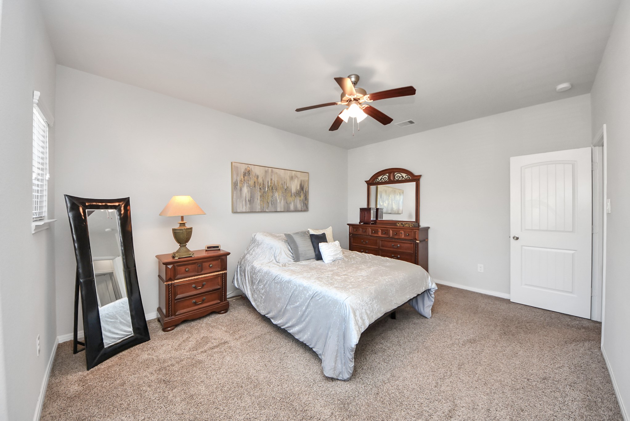 3310 Rainflower Springs Lane Rosenberg, TX 77471 - Photo 17 of 31 Well-sized bedroom with plush carpeting and a stylish aesthetic, ideal for guests or family members.