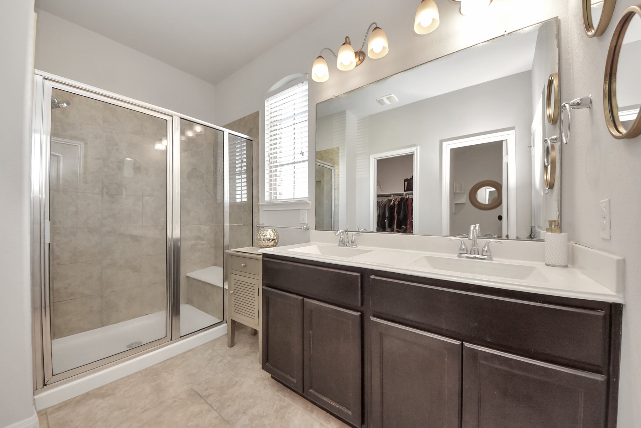 3310 Rainflower Springs Lane Rosenberg, TX 77471 - Photo 18 of 31 Spacious en-suite bathroom with dual vanities, a glass shower, and tasteful finishes, offering a spa-like experience.