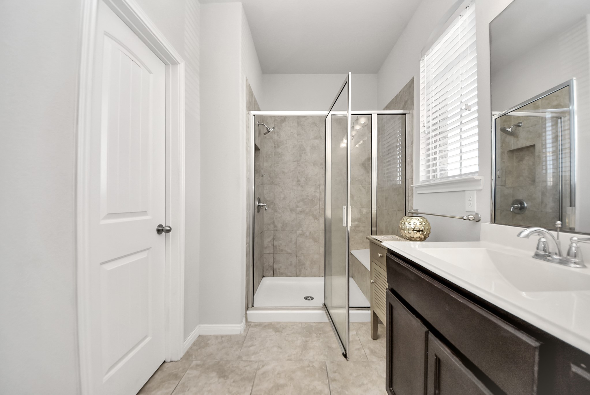 3310 Rainflower Springs Lane Rosenberg, TX 77471 - Photo 19 of 31 Updated bathroom with a clean, modern design, featuring a glass shower, vanity with sleek cabinetry, and natural light.