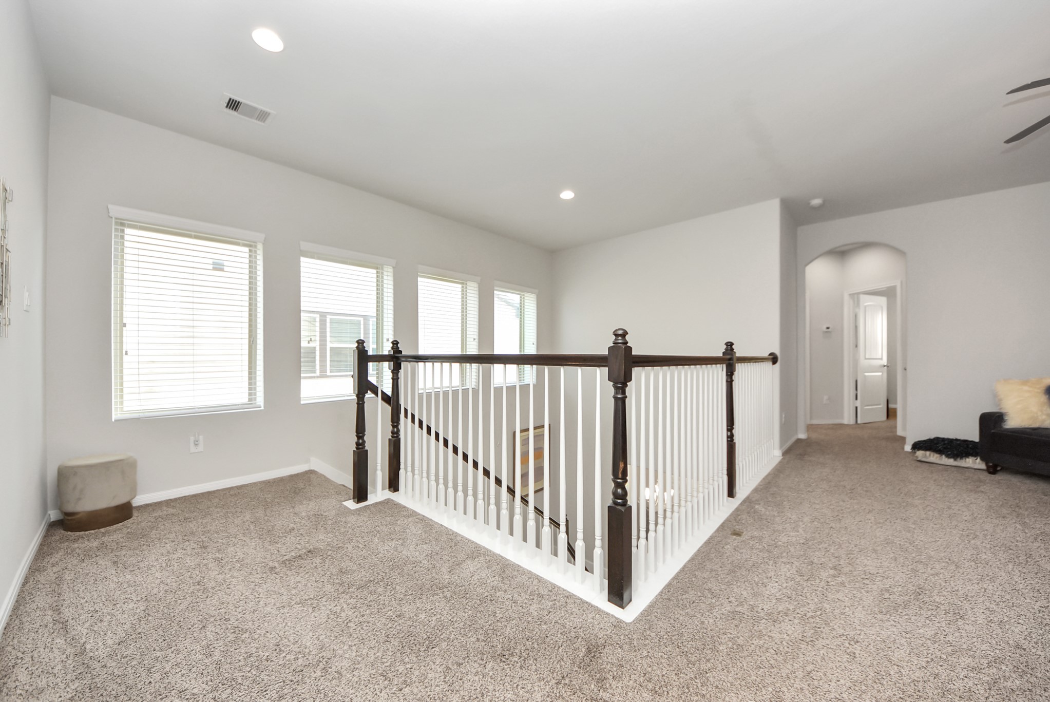 3310 Rainflower Springs Lane Rosenberg, TX 77471 - Photo 22 of 31 Enjoy the view from this bright hallway with a staircase leading to the upper levels, providing a seamless connection between rooms.