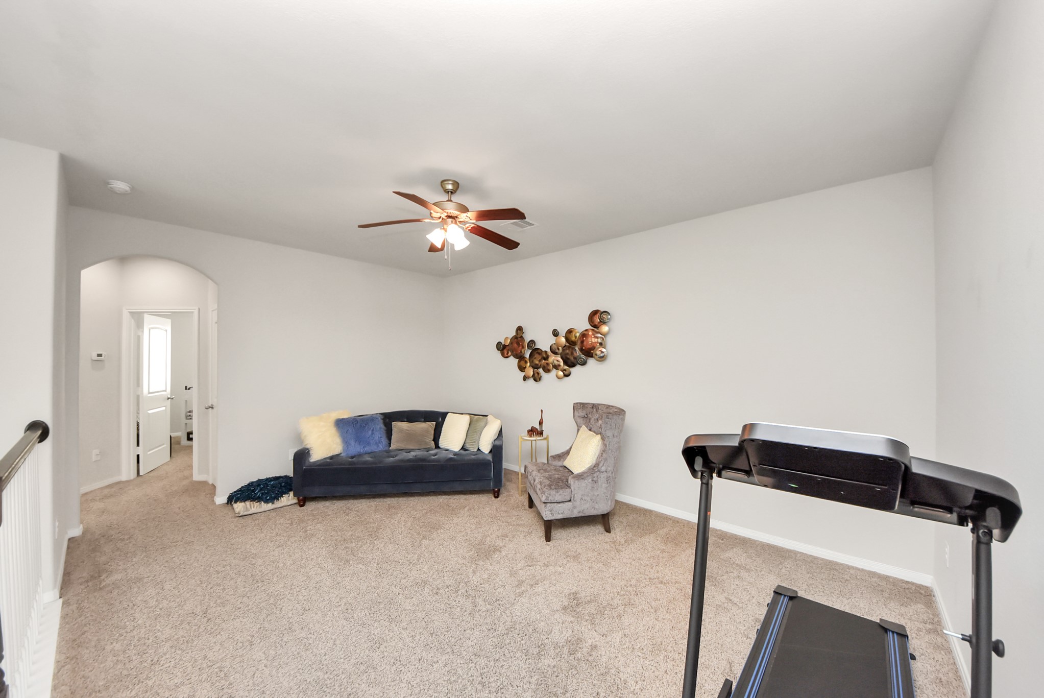 3310 Rainflower Springs Lane Rosenberg, TX 77471 - Photo 23 of 31 This spacious area offers ample room for relaxation, perfect for creating a cozy sitting area or a family entertainment zone.